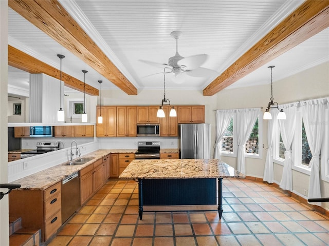 kitchen featuring a kitchen breakfast bar, sink, ceiling fan, a kitchen island, and stainless steel appliances