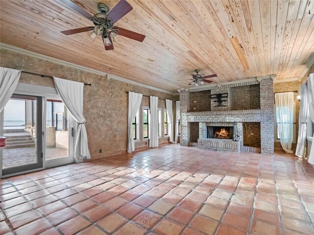 unfurnished living room with crown molding, ceiling fan, a fireplace, light tile patterned flooring, and wood ceiling