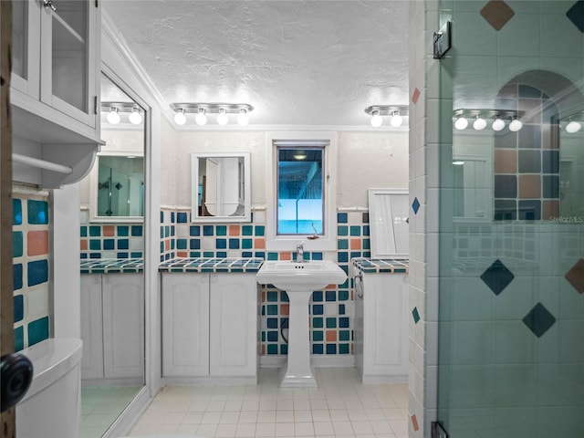 bathroom with sink, backsplash, a shower, a textured ceiling, and toilet