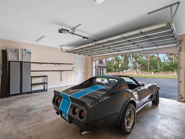 garage featuring a garage door opener and a carport