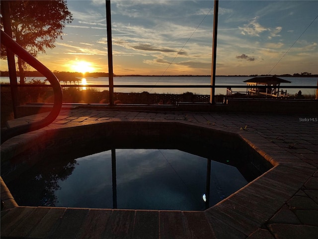 pool at dusk with a water view