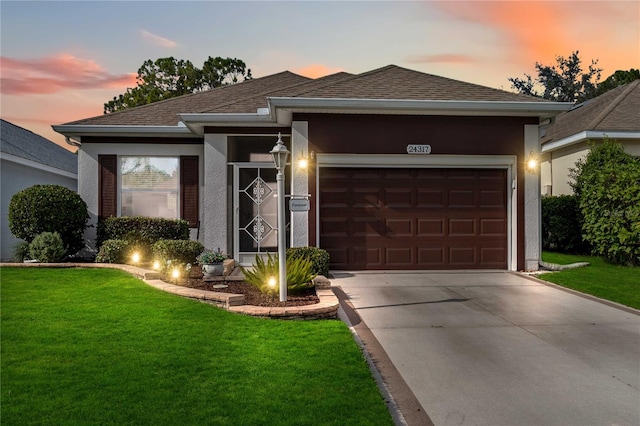 view of front facade with a lawn and a garage