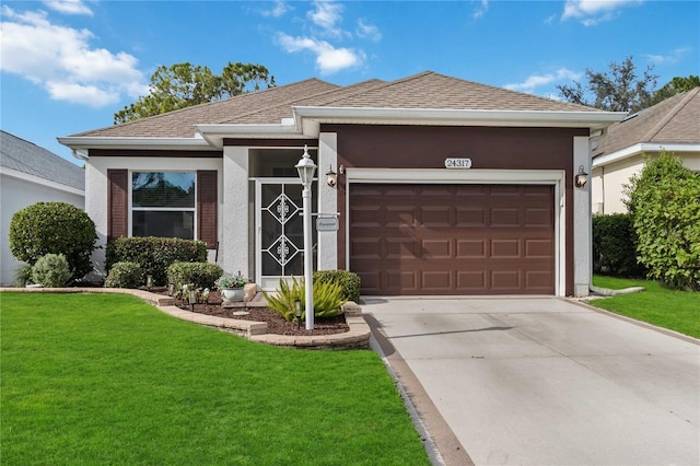 ranch-style home featuring a front lawn and a garage