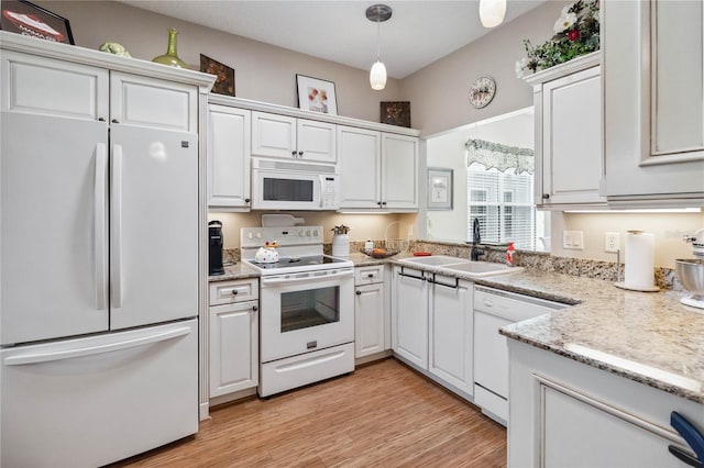 kitchen with white cabinetry, light hardwood / wood-style floors, and white appliances