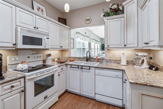 kitchen with white appliances, sink, and white cabinets