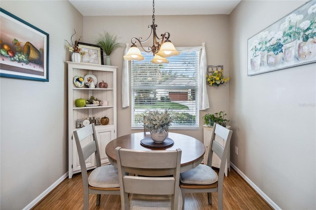 dining room with an inviting chandelier and hardwood / wood-style floors