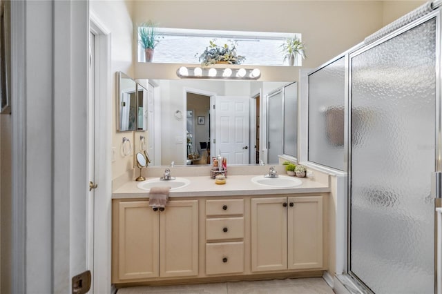 bathroom with a shower with door and vanity