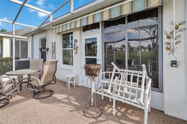 view of patio / terrace featuring glass enclosure