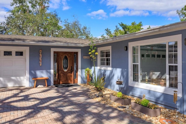 doorway to property featuring a garage