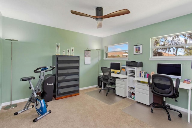 home office with ceiling fan, carpet floors, and a wealth of natural light