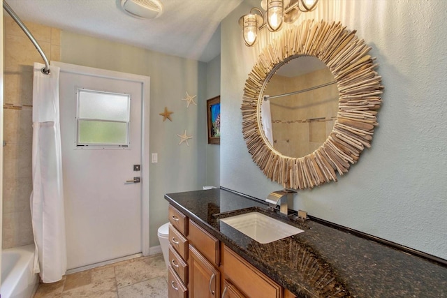 full bathroom featuring shower / tub combo, vanity, a textured ceiling, and toilet