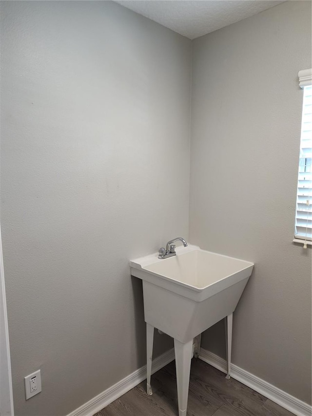 928 Nuthatch Ave, The Villages, FL 32163 - bathroom with wood finished floors, baseboards, and a sink