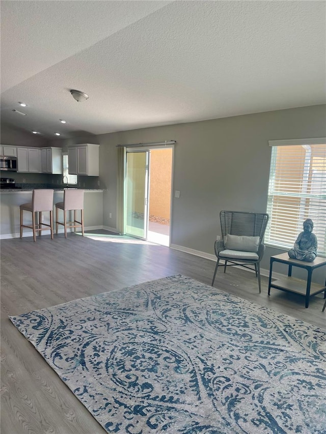 living area with plenty of natural light and light wood-style floors