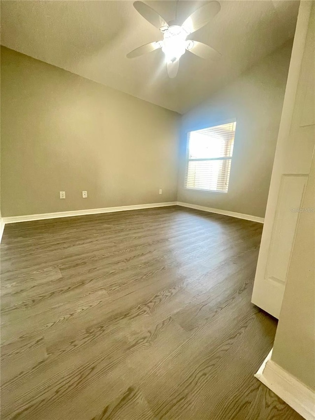 928 Nuthatch Ave, The Villages, FL 32163 - unfurnished room with dark wood finished floors, baseboards, ceiling fan, and lofted ceiling