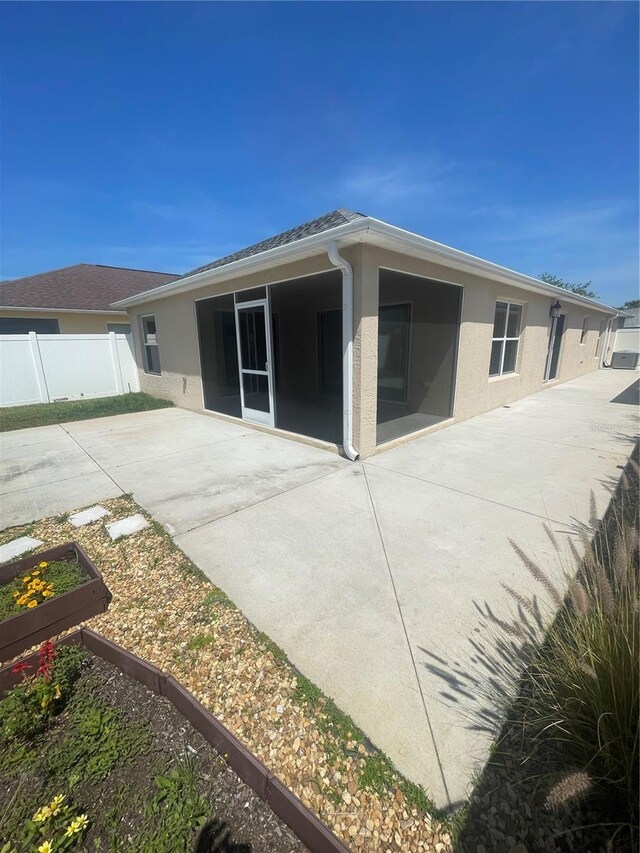 928 Nuthatch Ave, The Villages, FL 32163 - back of house with a garden, a patio, stucco siding, and fence