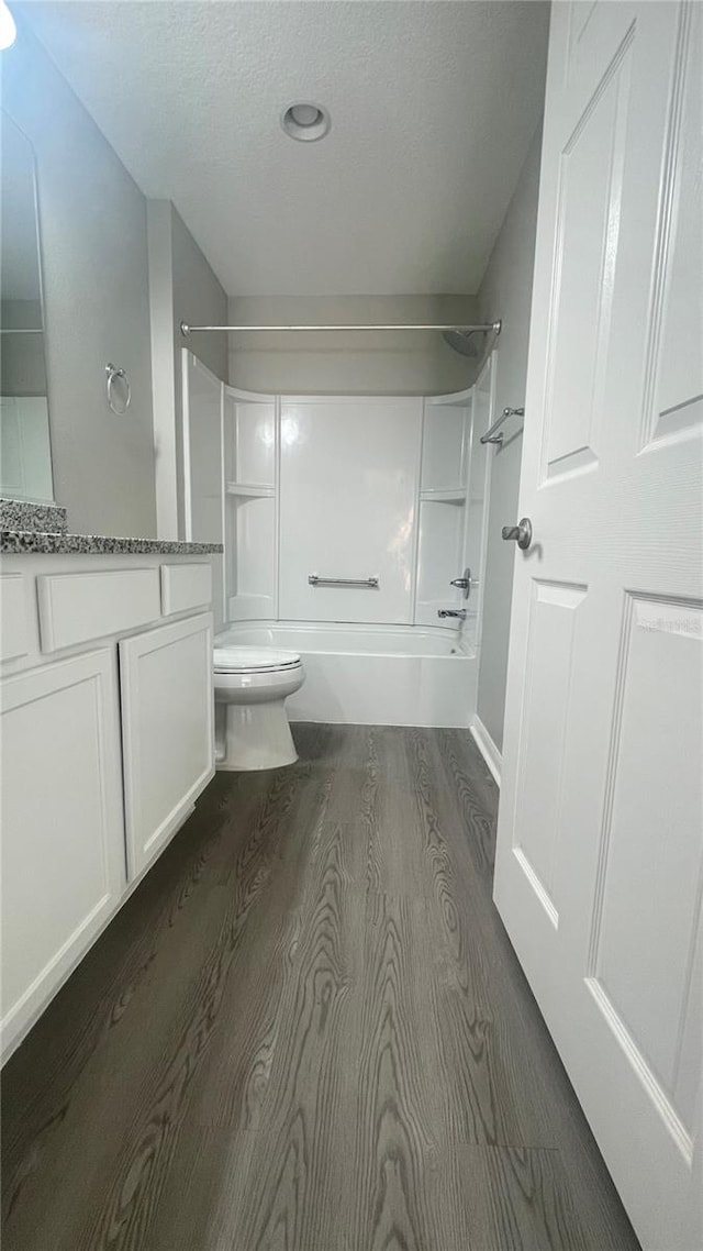 928 Nuthatch Ave, The Villages, FL 32163 - full bathroom featuring wood finished floors, bathtub / shower combination, toilet, vanity, and a textured ceiling