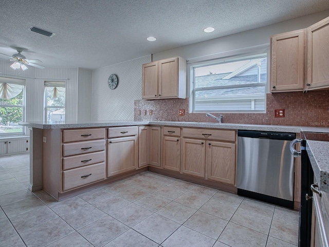 kitchen featuring stainless steel dishwasher, light brown cabinetry, light tile patterned floors, and kitchen peninsula