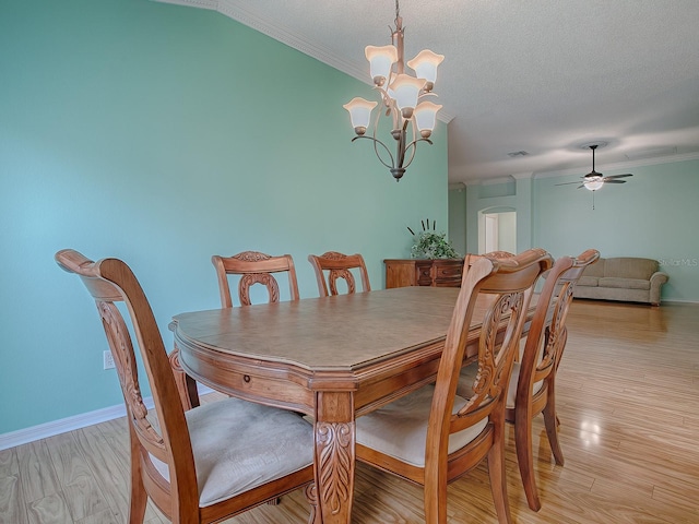 dining space featuring ceiling fan with notable chandelier, light hardwood / wood-style floors, a textured ceiling, and crown molding