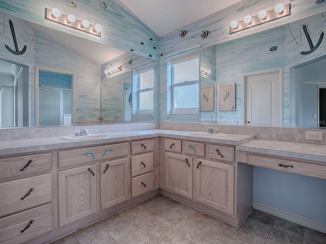 bathroom featuring tile patterned floors, vanity, a textured ceiling, vaulted ceiling, and a shower with shower door