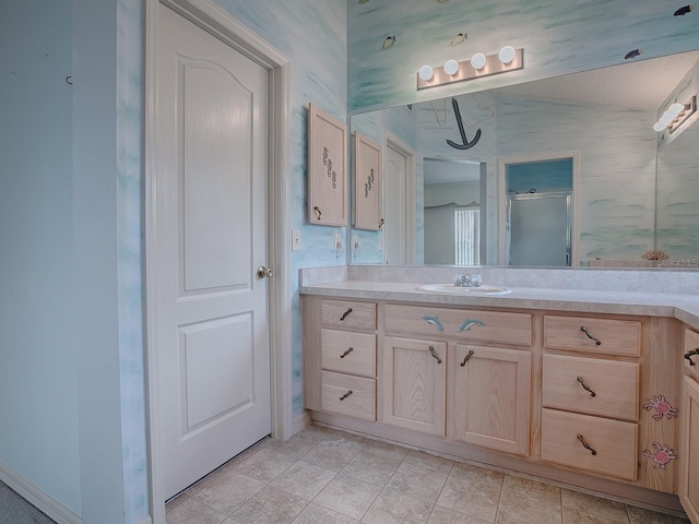 bathroom with vanity, an enclosed shower, lofted ceiling, and a textured ceiling