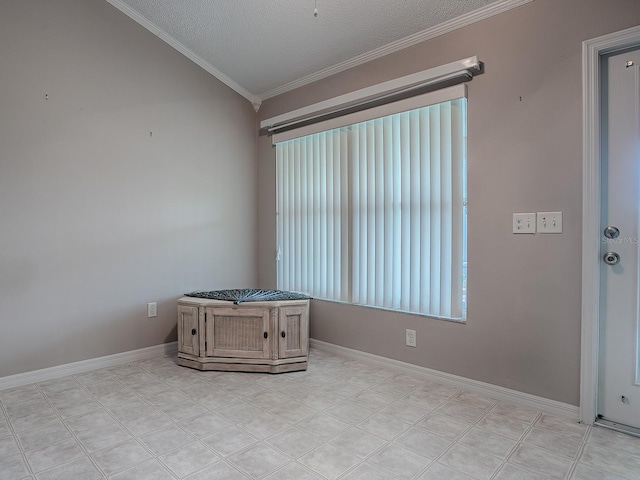 empty room with a textured ceiling, vaulted ceiling, and ornamental molding