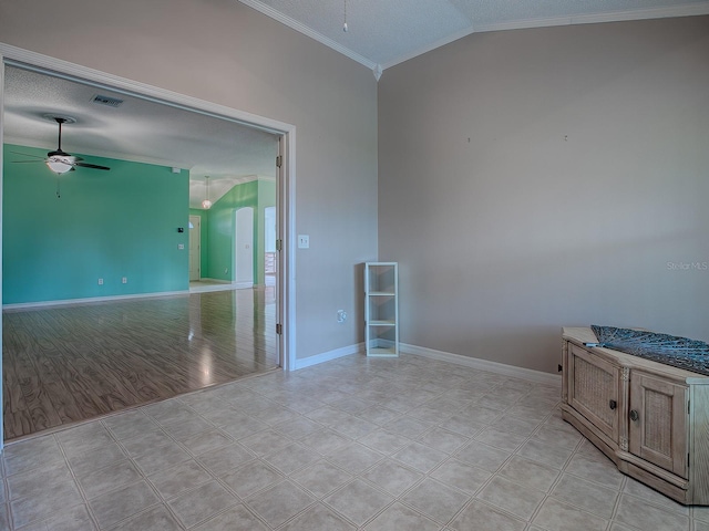 spare room featuring vaulted ceiling, a textured ceiling, ceiling fan, crown molding, and light hardwood / wood-style flooring