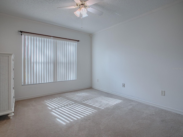 spare room with ceiling fan, light colored carpet, and a textured ceiling