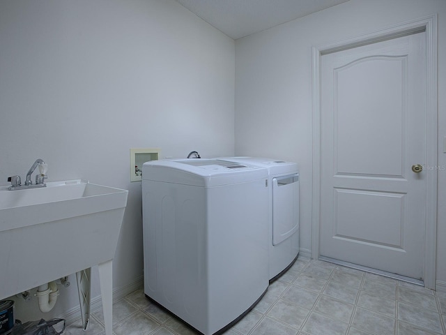 washroom featuring sink and independent washer and dryer