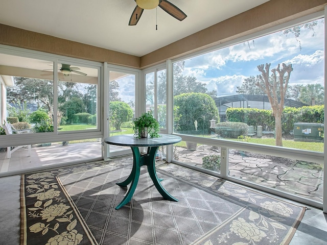 sunroom with ceiling fan and plenty of natural light