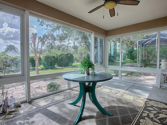 sunroom featuring ceiling fan