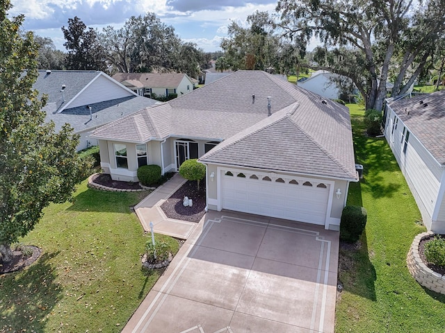 view of front of house featuring a garage, driveway, roof with shingles, stucco siding, and a front yard