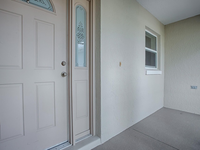 property entrance with stucco siding