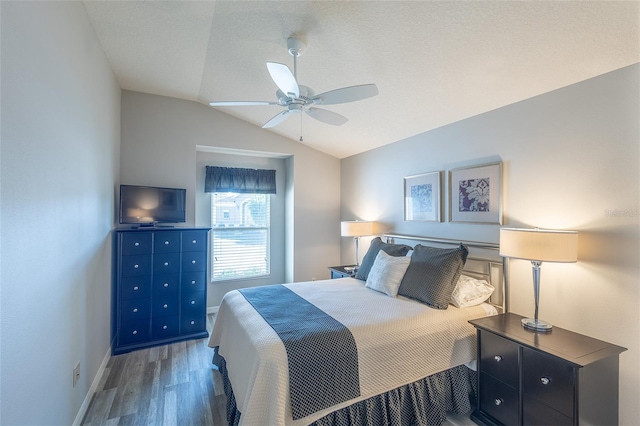 bedroom featuring lofted ceiling, ceiling fan, wood finished floors, and baseboards