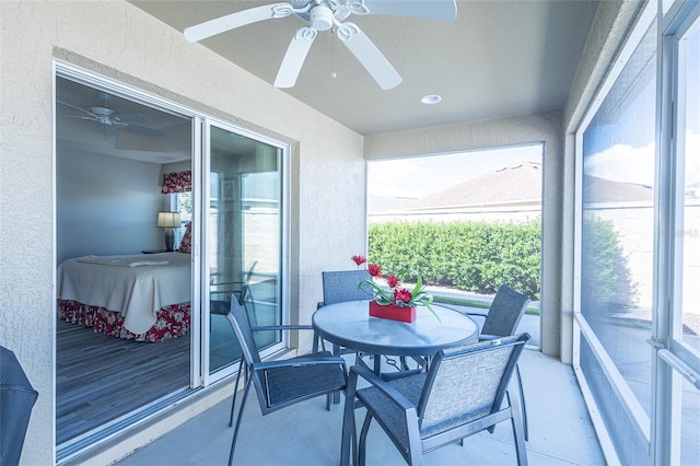 balcony featuring a sunroom and a ceiling fan