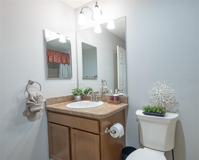 bathroom featuring toilet and vanity