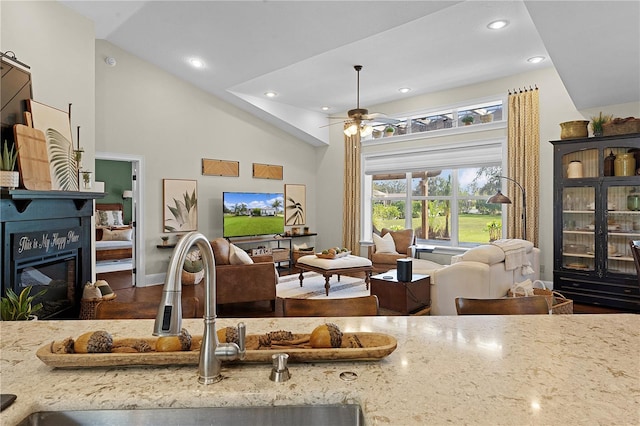 living room with high vaulted ceiling, sink, and ceiling fan