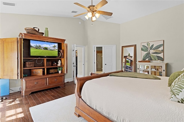 bedroom with dark wood-type flooring, high vaulted ceiling, and ceiling fan