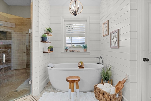 bathroom with a notable chandelier and independent shower and bath