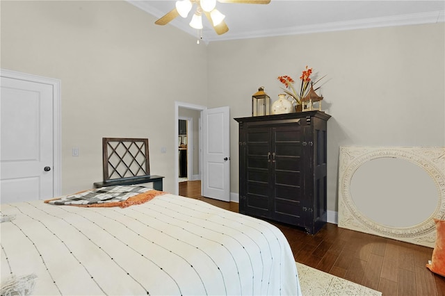 bedroom with ceiling fan, dark hardwood / wood-style floors, and crown molding