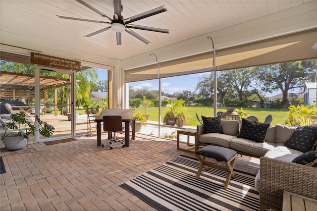 sunroom featuring ceiling fan