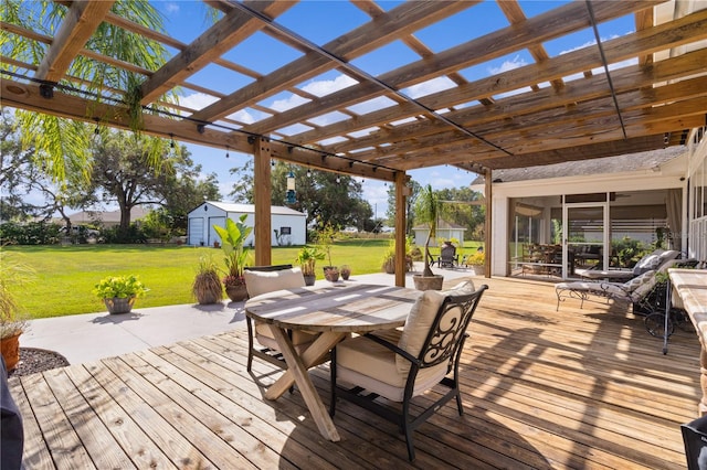 wooden deck with a sunroom, a pergola, and a yard