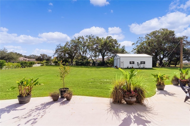 view of yard with an outdoor structure and a patio