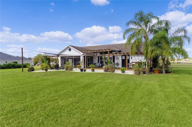 back of house with a sunroom, a pergola, and a yard