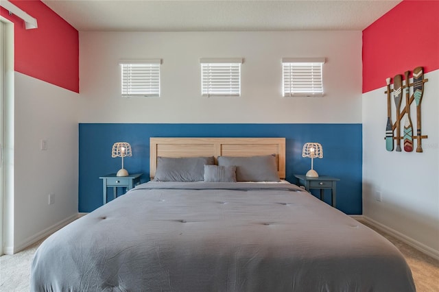 carpeted bedroom with multiple windows