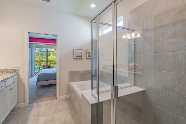 bathroom with vanity, tile patterned flooring, and plus walk in shower