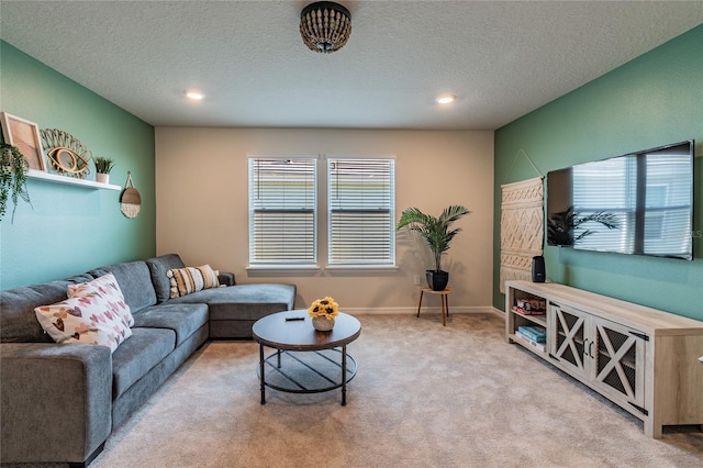 carpeted living room featuring a textured ceiling