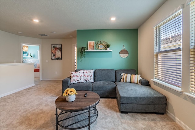 carpeted living room with a textured ceiling