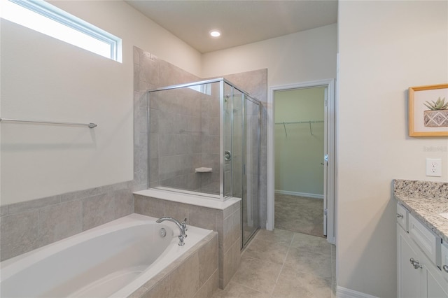 bathroom featuring vanity, plus walk in shower, and tile patterned floors