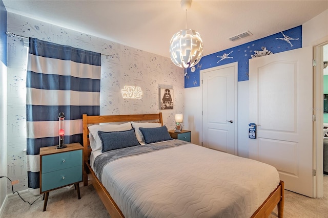 bedroom with carpet and a notable chandelier