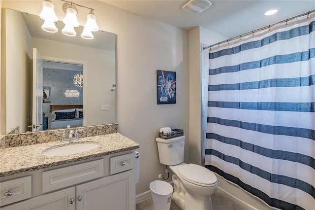 bathroom featuring walk in shower, vanity, and toilet